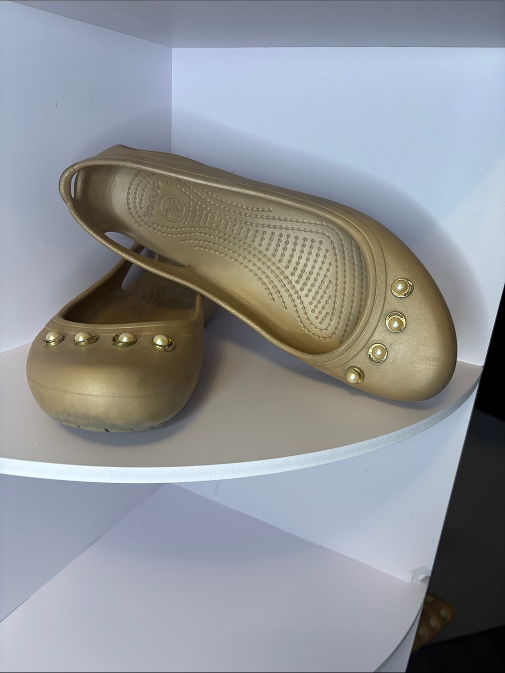 beige crocs flats with pearl accents